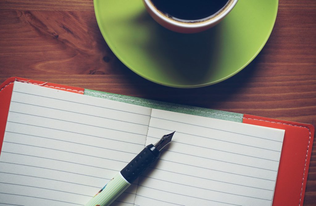 notepad with a cup of coffee